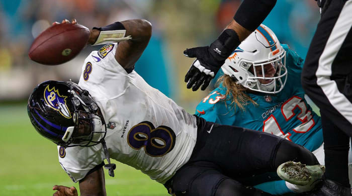 Baltimore Ravens quarterback Lamar Jackson (8), slams the ball after been sacked by Miami Dolphins outside linebacker Andrew Van Ginkel (43), late in the first quarter of their NFL game at Hard Rock Stadium Thursday in Miami Gardens.